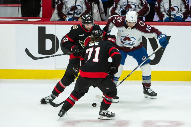 Mar 20, 2025; Ottawa, Ontario, CAN; Ottawa Senators center Ridly Greig (71) moves the puck as right wing Michael Amadio (22) defends against Colorado Avalanche defenseman Sam Malinski (70) in the third period at the Canadian Tire Centre. Mandatory Credit: Marc DesRosiers-Imagn Images