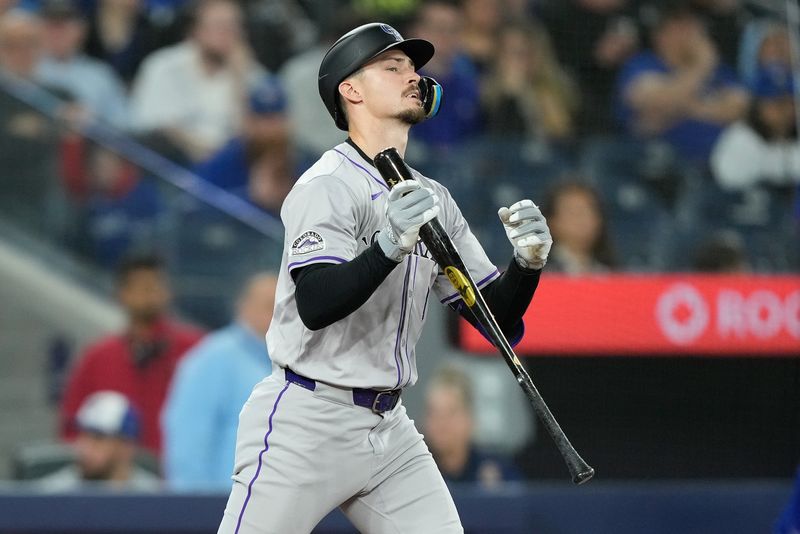 Apr 14, 2024; Toronto, Ontario, CAN; Colorado Rockies center fielder Brenton Doyle (9) reacts after striking out against the Toronto Blue Jays during the sixth inning at Rogers Centre. Mandatory Credit: John E. Sokolowski-USA TODAY Sports