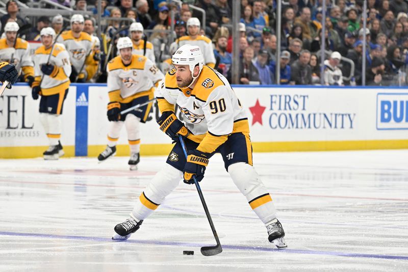 Nov 24, 2023; St. Louis, Missouri, USA;  Nashville Predators center Ryan O'Reilly (90) controls the puck against the St. Louis Blues during the first period at Enterprise Center. Mandatory Credit: Jeff Curry-USA TODAY Sports