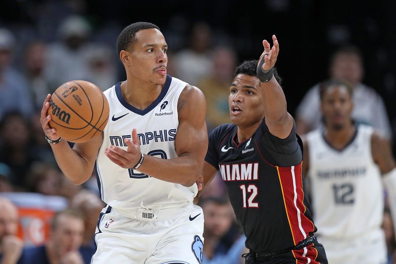 MEMPHIS, TENNESSEE - OCTOBER 18: Desmond Bane #22 of the Memphis Grizzlies handles the ball against Dru Smith #12 of the Miami Heat during the first half at FedExForum on October 18, 2024 in Memphis, Tennessee. NOTE TO USER: User expressly acknowledges and agrees that, by downloading and or using this photograph, User is consenting to the terms and conditions of the Getty Images License Agreement. (Photo by Justin Ford/Getty Images)