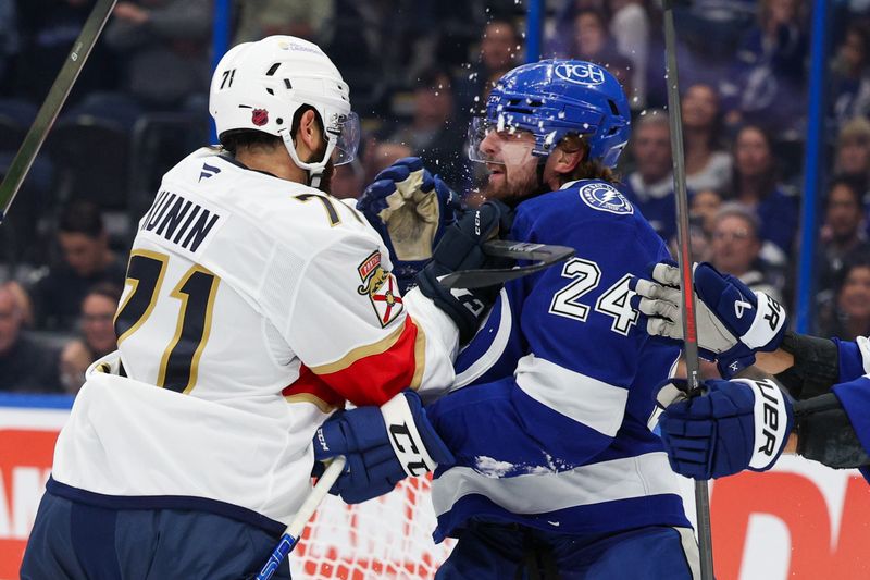 Oct 2, 2025; Tampa, Florida, USA; Florida Panthers center Luke Kunin (71) shoves Tampa Bay Lightning defenseman Max Crozier (24) in the first period at Benchmark International Arena. Mandatory Credit: Nathan Ray Seebeck-Imagn Images