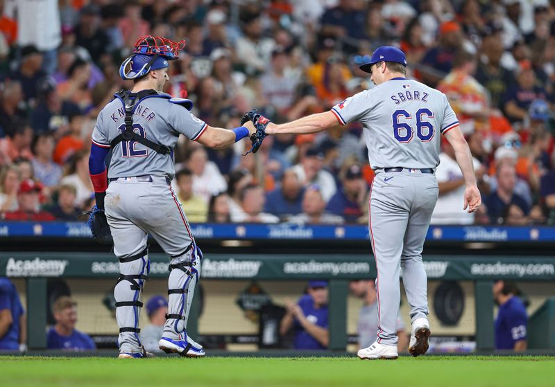 Jul 14, 2024; Houston, Texas, USA; Texas Rangers relief pitcher Josh Sborz (66) celebrates with catcher Andrew Knizner (12) after the end of the fifth inning against the Houston Astros at Minute Maid Park. Mandatory Credit: Troy Taormina-USA TODAY Sports