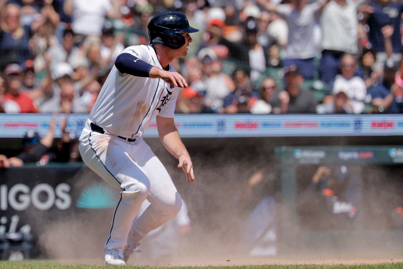 May 26, 2025; Detroit, Michigan, USA;  Detroit Tigers second base Colt Keith (33) slides in safe at home against the San Francisco Giants in the fourth inning at Comerica Park. Mandatory Credit: Rick Osentoski-Imagn Images