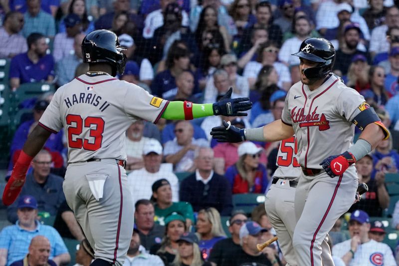 May 22, 2024; Chicago, Illinois, USA; Atlanta Braves outfielder Adam Duvall (14) celebrates his two-run home run with outfielder Michael Harris II (23) against the Chicago Cubs during the third inning at Wrigley Field. Mandatory Credit: David Banks-USA TODAY Sports