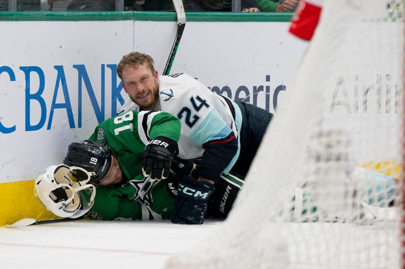 May 15, 2023; Dallas, Texas, USA; Seattle Kraken defenseman Jamie Oleksiak (24) loses his helmet after he takes down Dallas Stars center Max Domi (18) during the second period in game seven of the second round of the 2023 Stanley Cup Playoffs at the American Airlines Center. Mandatory Credit: Jerome Miron-USA TODAY Sports