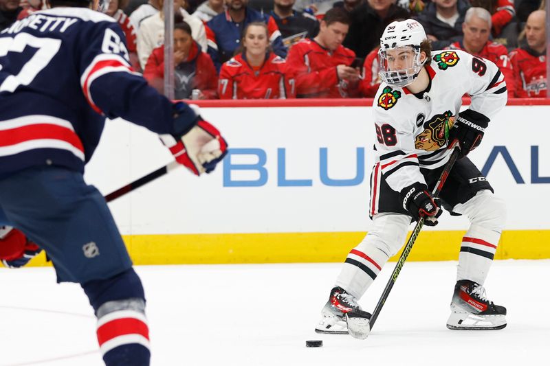 Mar 9, 2024; Washington, District of Columbia, USA; Chicago Blackhawks center Connor Bedard (98) skates with the puck as Washington Capitals left wing Max Pacioretty (67) defends in the second period at Capital One Arena. Mandatory Credit: Geoff Burke-USA TODAY Sports