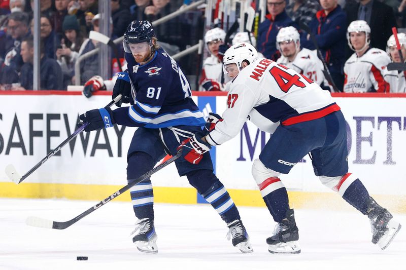 Mar 11, 2024; Winnipeg, Manitoba, CAN; Winnipeg Jets left wing Kyle Connor (81) is checked by Washington Capitals left wing Beck Malenstyn (47) in the first period at Canada Life Centre. Mandatory Credit: James Carey Lauder-USA TODAY Sports