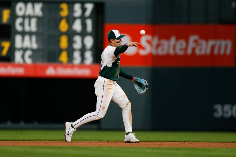 Apr 20, 2024; Denver, Colorado, USA; Colorado Rockies second baseman Alan Trejo (13) makes a throw to first for an out in the fifth inning against the Seattle Mariners at Coors Field. Mandatory Credit: Isaiah J. Downing-USA TODAY Sports