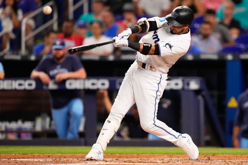 Jun 20, 2023; Miami, Florida, USA; Miami Marlins second baseman Luis Arraez (3) hits a single against the Toronto Blue Jays during the fourth inning at loanDepot Park. Mandatory Credit: Rich Storry-USA TODAY Sports