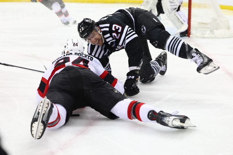 Mar 23, 2024; Newark, New Jersey, USA; New Jersey Devils defenseman Kurtis MacDermid (23) and Ottawa Senators defenseman Jacob Bernard-Docker (24) collide during the second period at Prudential Center. Mandatory Credit: Ed Mulholland-USA TODAY Sports