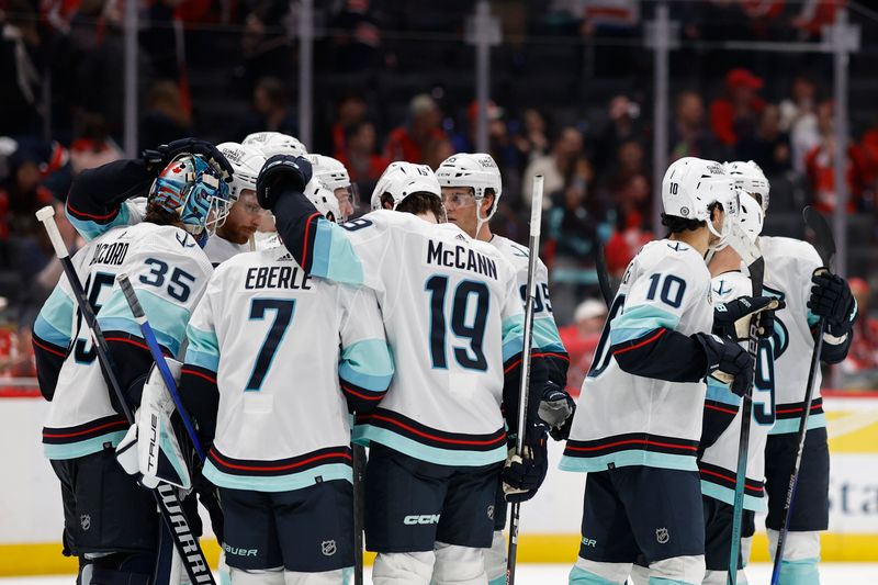 Jan 11, 2024; Washington, District of Columbia, USA; Seattle Kraken goaltender Joey Daccord (35) celebrates with teammates after their game against the Washington Capitals at Capital One Arena. Mandatory Credit: Geoff Burke-USA TODAY Sports