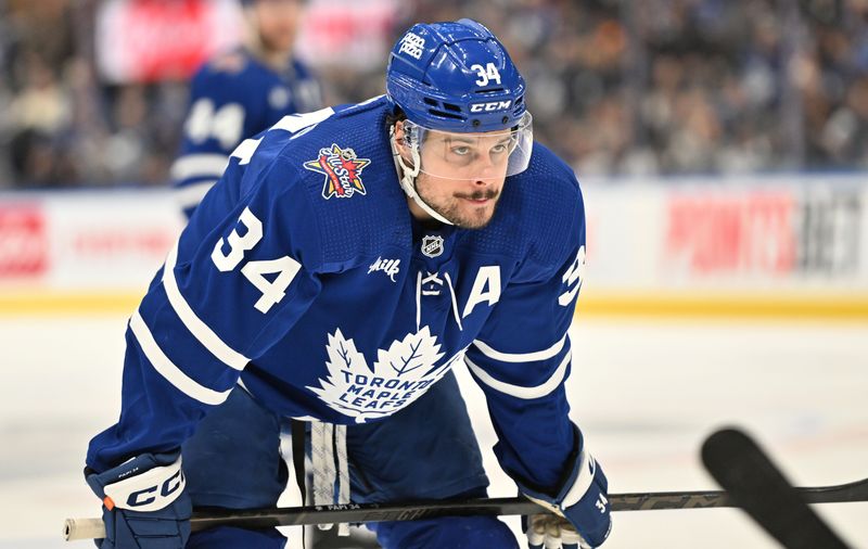 Jan 14, 2024; Toronto, Ontario, CAN;  Toronto Maple Leafs forward Auston Matthews (34) prepares to take a faceoff against the Detroit Red Wings in the third period at Scotiabank Arena. Mandatory Credit: Dan Hamilton-USA TODAY Sports