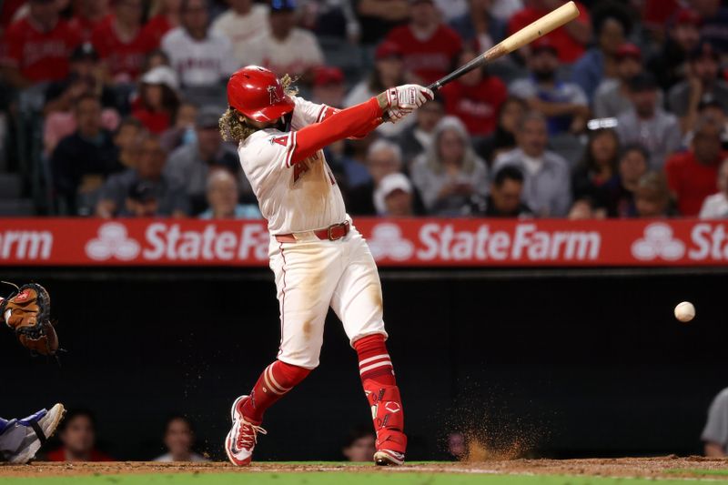 Sep 28, 2024; Anaheim, California, USA;  Los Angeles Angels shortstop Jack Lopez (10) hits a RBI single during the second inning against the Texas Rangers at Angel Stadium. Mandatory Credit: Kiyoshi Mio-Imagn Images