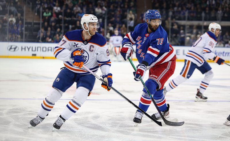 Mar 16, 2025; New York, New York, USA; Edmonton Oilers center Connor McDavid (97) skates by New York Rangers defenseman K'Andre Miller (79) during the first period at Madison Square Garden. Mandatory Credit: Danny Wild-Imagn Images