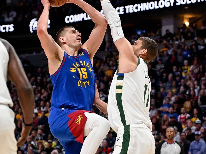 DENVER, CO - MARCH 25:  Nikola Jokic #15 of the Denver Nuggets shoots under coverage by Brook Lopez #11 of the Milwaukee Bucks at Ball Arena on March 25, 2023 in Denver, Colorado. NOTE TO USER: User expressly acknowledges and agrees that, by downloading and or using this photograph, User is consenting to the terms and conditions of the Getty Images License Agreement. (Photo by Dustin Bradford/Getty Images)