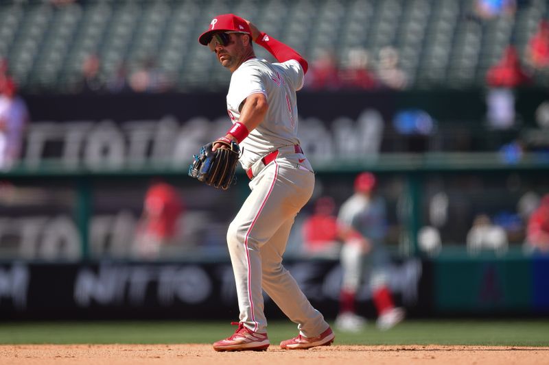 May 1, 2024; Anaheim, California, USA; Philadelphia Phillies second baseman Whit Merrifield (9) throws for the out at first against Los Angeles Angels third base Ehire Adrianza (13) during the ninth inning at Angel Stadium. Mandatory Credit: Gary A. Vasquez-USA TODAY Sports