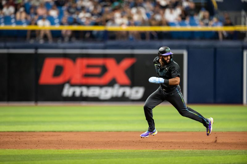 May 11, 2024; St. Petersburg, Florida, USA; Tampa Bay Rays outfielder Amed Rosario (10) runs to third base against the New York Yankees during the seventh inning at Tropicana Field. Mandatory Credit: Matt Pendleton-USA TODAY Sports