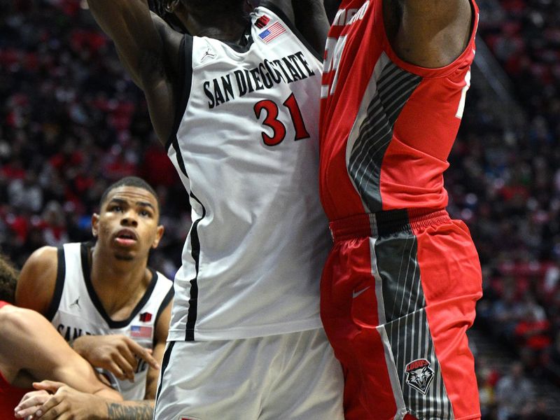 Jan 14, 2023; San Diego, California, USA; New Mexico Lobos forward Morris Udeze (24) shoots the ball while defended by San Diego State Aztecs forward Nathan Mensah (31) during the second half at Viejas Arena. Mandatory Credit: Orlando Ramirez-USA TODAY Sports