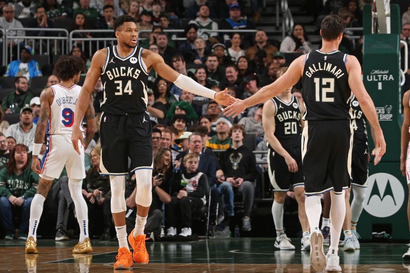 MILWAUKEE, WI - MARCH 14: Giannis Antetokounmpo #34 of the Milwaukee Bucks high fives Danilo Gallinari #12 during the game against the Philadelphia 76ers on March 14, 2024 at the Fiserv Forum Center in Milwaukee, Wisconsin. NOTE TO USER: User expressly acknowledges and agrees that, by downloading and or using this Photograph, user is consenting to the terms and conditions of the Getty Images License Agreement. Mandatory Copyright Notice: Copyright 2024 NBAE (Photo by Gary Dineen/NBAE via Getty Images).