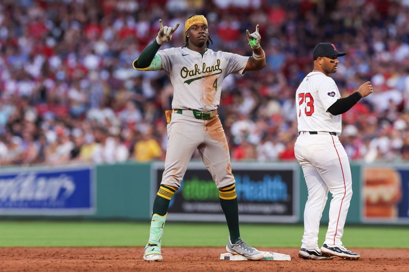 Jul 10, 2024; Boston, Massachusetts, USA; Oakland Athletics right fielder Lawrence Butler (4) celebrates after hitting a two run RBI double during the second inning against the Boston Red Sox at Fenway Park. Mandatory Credit: Paul Rutherford-USA TODAY Sports