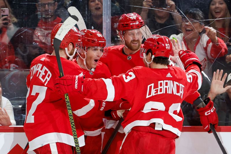 Jan 13, 2024; Detroit, Michigan, USA;  Detroit Red Wings right wing Patrick Kane (88) receives congratulations from teammates after scoring in the second period against the Los Angeles Kings at Little Caesars Arena. Mandatory Credit: Rick Osentoski-USA TODAY Sports