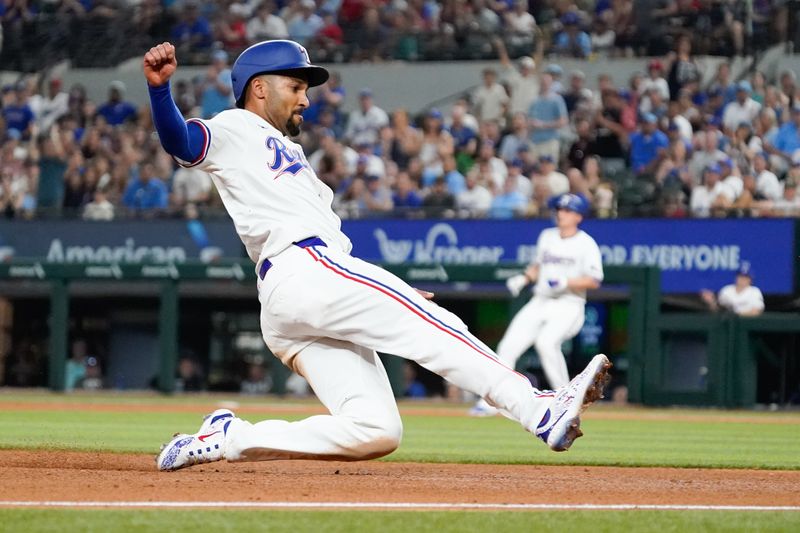 May 18, 2024; Arlington, Texas, USA; Texas Rangers second baseman Marcus Semien (2) slides into third base during the eighth inning against the Los Angeles Angels at Globe Life Field. Mandatory Credit: Raymond Carlin III-USA TODAY Sports