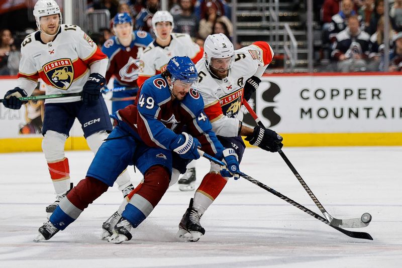 Jan 6, 2024; Denver, Colorado, USA; Colorado Avalanche defenseman Samuel Girard (49) and Florida Panthers defenseman Aaron Ekblad (5) battle for the puck in the first period at Ball Arena. Mandatory Credit: Isaiah J. Downing-USA TODAY Sports