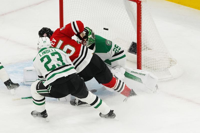 Jan 1, 2026; Chicago, Illinois, USA; Dallas Stars defenseman Esa Lindell (23) defends Chicago Blackhawks right wing Ilya Mikheyev (95) as he scores a goal on goaltender Jake Oettinger (29) during the second period at United Center. Mandatory Credit: David Banks-Imagn Images