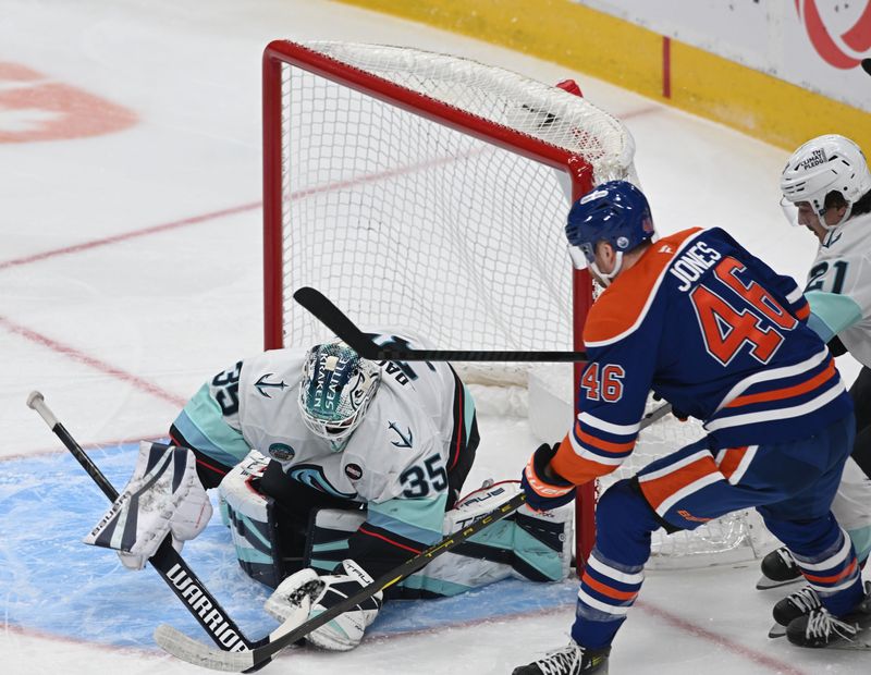 Mar 22, 2025; Edmonton, Alberta, CAN;  Seattle Kraken goalie Joey Daccord (35) with Edmonton Oilers left winger Max Jones (46) are seen out on the ice during the first period at Rogers Place. Mandatory Credit: Walter Tychnowicz-Imagn Images