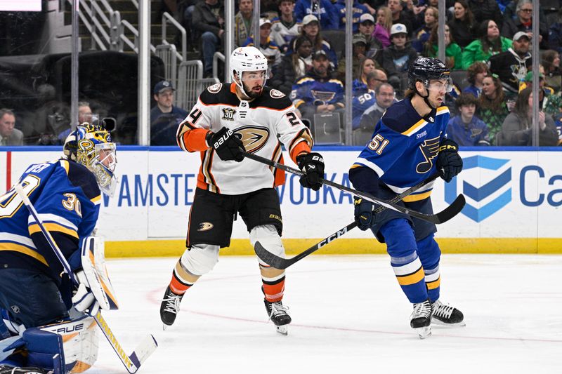 Mar 17, 2024; St. Louis, Missouri, USA; Anaheim Ducks center Bo Groulx (24) and St. Louis Blues defenseman Matthew Kessel (51) battle in front of of the net during the third period at Enterprise Center. Mandatory Credit: Jeff Le-USA TODAY Sports