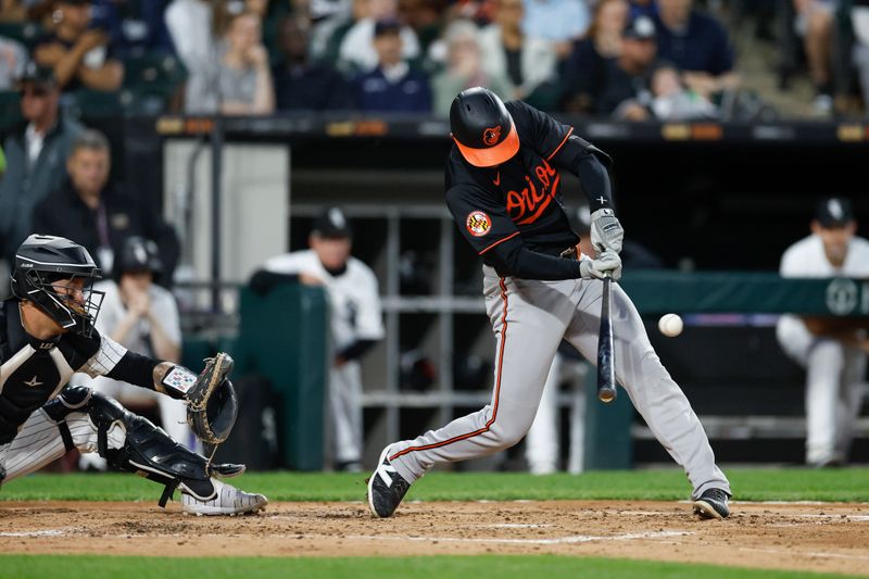 May 24, 2024; Chicago, Illinois, USA; Baltimore Orioles third baseman Jordan Westburg (11) hits an RBI-double against the Chicago White Sox during the third inning at Guaranteed Rate Field. Mandatory Credit: Kamil Krzaczynski-USA TODAY Sports