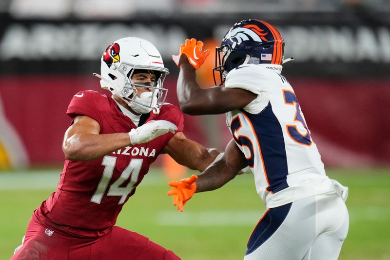 Arizona Cardinals wide receiver Michael Wilson (14) blocks Denver Broncos cornerback Ja'Quan McMillian, right, during the first half of an NFL preseason football game, Friday, Aug. 11, 2023, in Glendale, Ariz. (AP Photo/Ross D. Franklin)