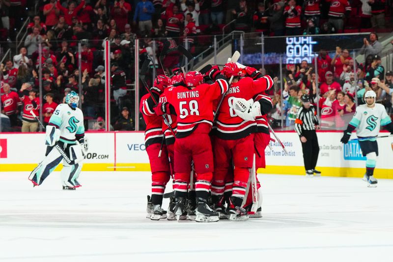 Oct 26, 2023; Raleigh, North Carolina, USA; Carolina Hurricanes players celebrate there victory against the Seattle Kraken in the over time at PNC Arena. Mandatory Credit: James Guillory-USA TODAY Sports