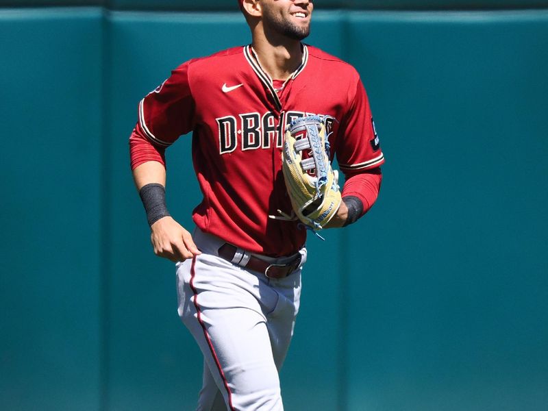 May 17, 2023; Oakland, California, USA; Arizona Diamondbacks left fielder Lourdes Gurriel Jr. (12) smiles after a win against the Oakland Athletics at Oakland-Alameda County Coliseum. Mandatory Credit: Kelley L Cox-USA TODAY Sports