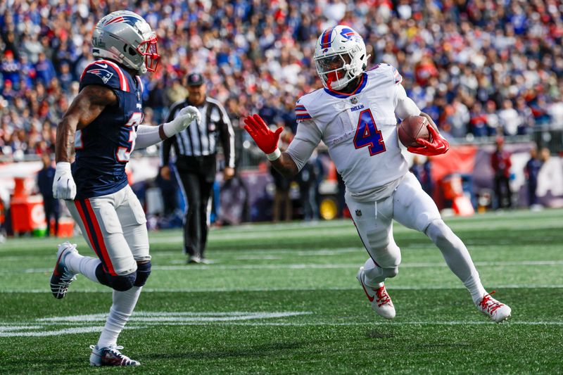 Buffalo Bills running back James Cook (4) evades New England Patriots cornerback Jonathan Jones (31) during the first half of an NFL football game against the New England Patriots on Sunday, Oct. 22, 2023, in Foxborough, Mass. (AP Photo/Greg M. Cooper)