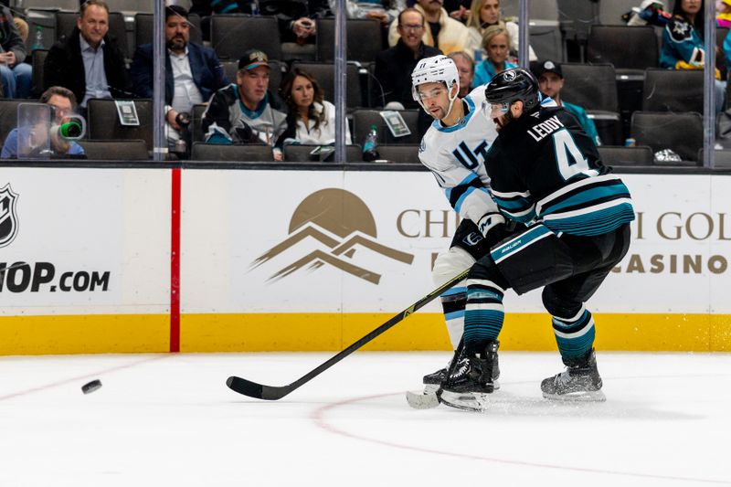 Nov 18, 2025; San Jose, California, USA; Utah Mammoth right wing Dylan Guenther (11) shoots during the third period against the San Jose Sharks at SAP Center at San Jose. Mandatory Credit: Bob Kupbens-Imagn Images
