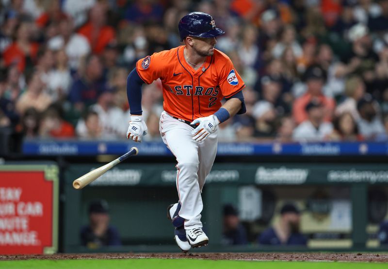 May 3, 2024; Houston, Texas, USA; Houston Astros third baseman Alex Bregman (2) hits a single during the fourth inning against the Seattle Mariners at Minute Maid Park. Mandatory Credit: Troy Taormina-USA TODAY Sports