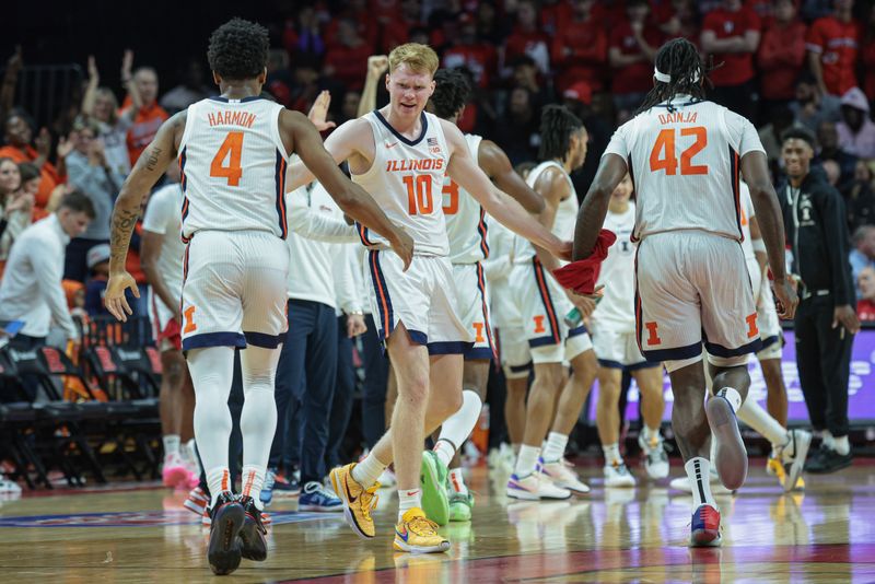 Dec 2, 2023; Piscataway, New Jersey, USA; Illinois Fighting Illini guard Luke Goode (10) celebrates with guard Justin Harmon (4) and forward Dain Dainja (42) during a time out during the first half against the Rutgers Scarlet Knights at Jersey Mike's Arena. Mandatory Credit: Vincent Carchietta-USA TODAY Sports