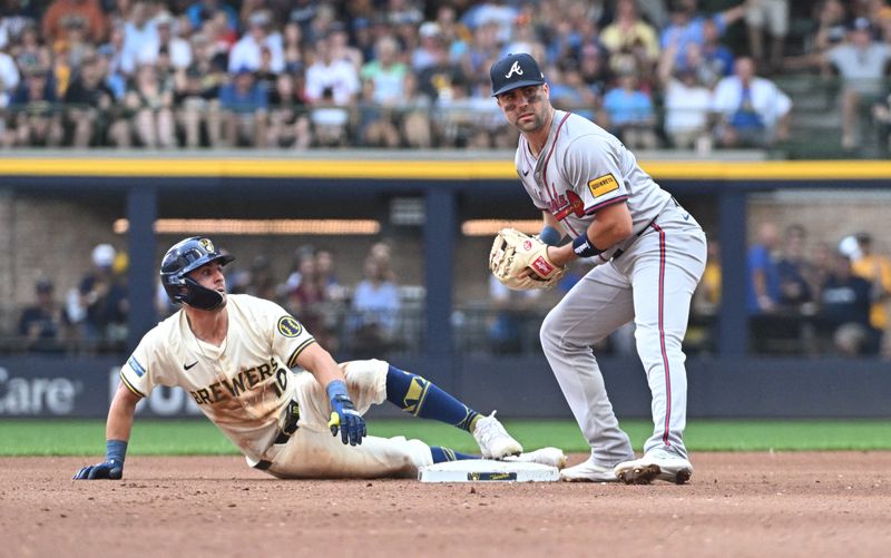 Jul 31, 2024; Milwaukee, Wisconsin, USA; Milwaukee Brewers outfielder Sal Frelick (10) is tagged out at second base by Atlanta Braves second baseman Whit Merrifield (15) while trying to stretch a single into a double during the fourth inning at American Family Field. Mandatory Credit: Michael McLoone-USA TODAY Sports