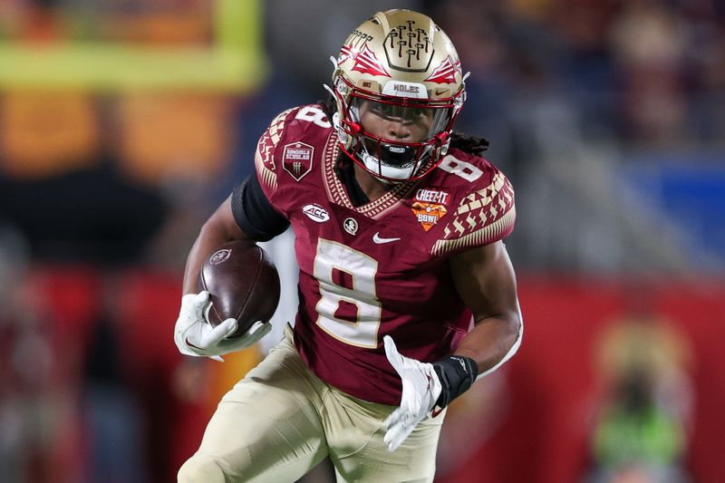 Dec 29, 2022; Orlando, Florida, USA; Florida State Seminoles running back Treshaun Ward (8) runs with the ball against the Oklahoma Sooners in the fourth quarter during the 2022 Cheez-It Bowl at Camping World Stadium. Mandatory Credit: Nathan Ray Seebeck-USA TODAY Sports