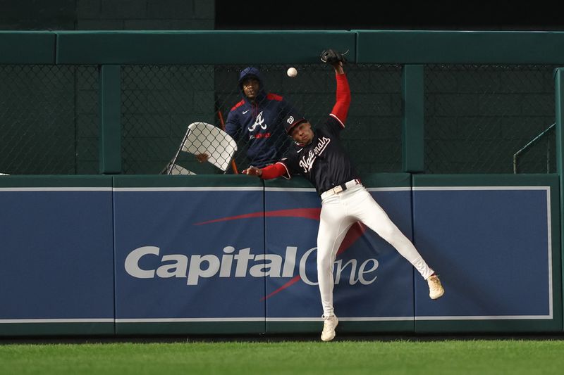 Sep 16, 2025; Washington, District of Columbia, USA; Washington Nationals outfielder Daylen Lile (51) attempts to catch a double hit by Atlanta Braves outfielder Michael Harris II (not pictured) during the seventh inning at Nationals Park. Mandatory Credit: Geoff Burke-Imagn Images