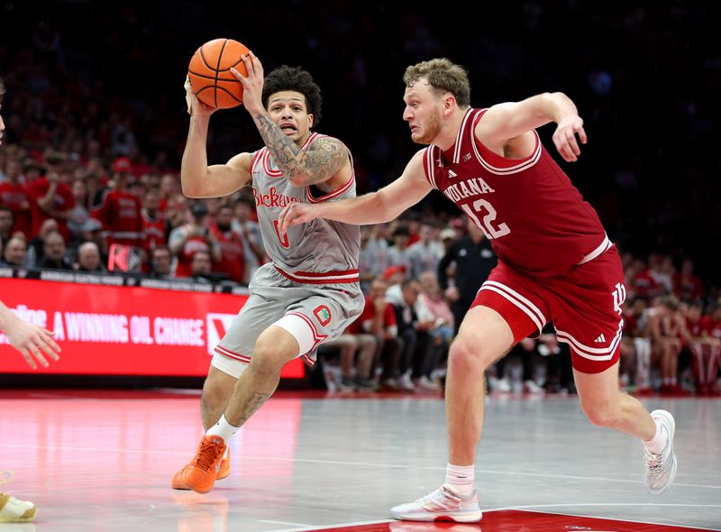 Mar 7, 2026; Columbus, Ohio, USA; Ohio State Buckeyes guard John Mobley Jr. (0) drives to the basket as Indiana Hoosiers forward Tucker Devries (12) defends during the second half at Value City Arena. Mandatory Credit: Joseph Maiorana-Imagn Images