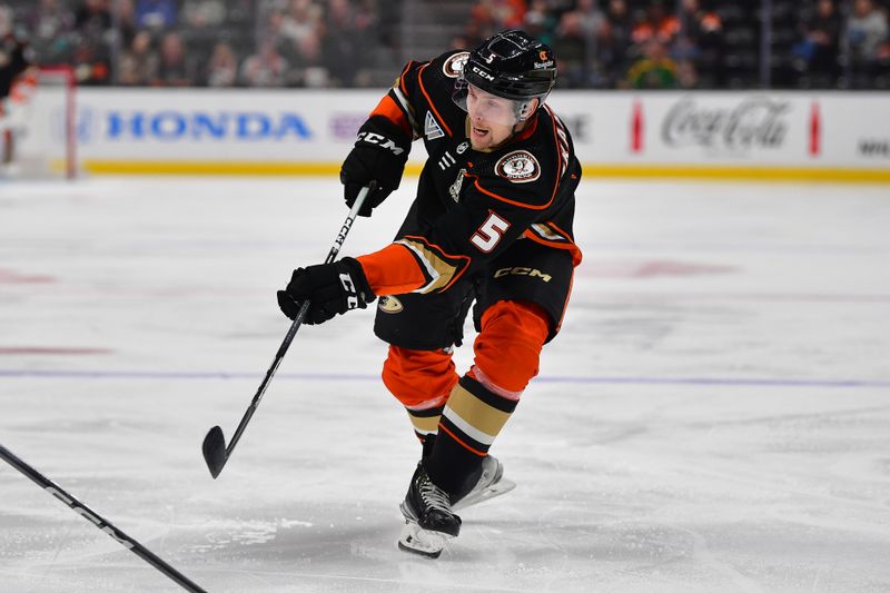 Feb 21, 2024; Anaheim, California, USA; Anaheim Ducks defenseman Urho Vaakanainen (5) shoots on goal against the Columbus Blue Jackets during the first period at Honda Center. Mandatory Credit: Gary A. Vasquez-USA TODAY Sports