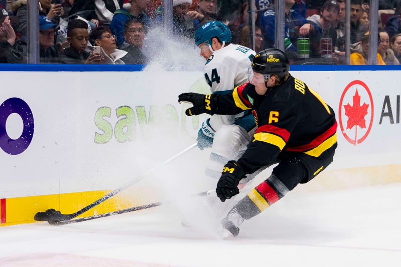 Dec 23, 2023; Vancouver, British Columbia, CAN; Vancouver Canucks forward Brock Boeser (6) checks San Jose Sharks defenseman Marc-Edouard Vlasic (44) in the first period at Rogers Arena. Mandatory Credit: Bob Frid-USA TODAY Sports