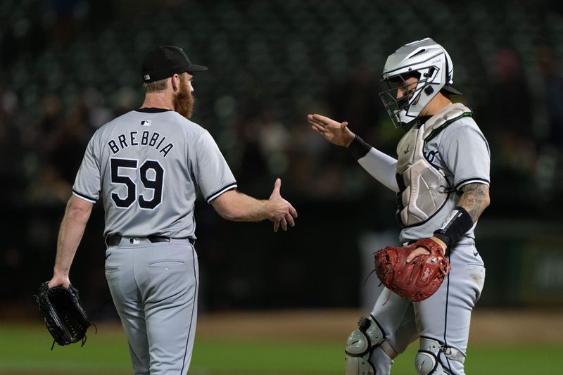 Aug 6, 2024; Oakland, California, USA;  Chicago White Sox pitcher John Brebbia (59) and catcher Korey Lee (26) celebrate after defeating the Oakland Athletics at Oakland-Alameda County Coliseum. Mandatory Credit: Stan Szeto-USA TODAY Sports