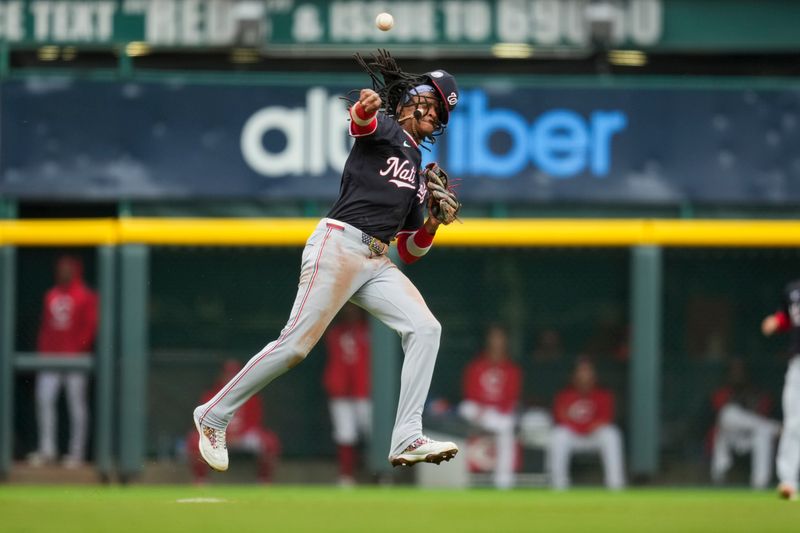 May 4, 2025; Cincinnati, Ohio, USA;  Washington Nationals shortstop CJ Abrams (5) fields the ball and attempts to throw out Cincinnati Reds outfielder Spencer Steer (7) in the fourth inning inning at Great American Ball Park. Mandatory Credit: Aaron Doster-Imagn Images