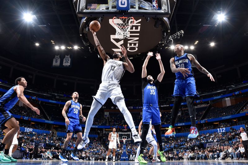 ORLANDO, FL - FEBRUARY 27: Keita Bates-Diop #13 of the Brooklyn Nets drives to the basket during the game against the Orlando Magic on February 27, 2024 at the Kia Center in Orlando, Florida. NOTE TO USER: User expressly acknowledges and agrees that, by downloading and or using this photograph, User is consenting to the terms and conditions of the Getty Images License Agreement. Mandatory Copyright Notice: Copyright 2024 NBAE (Photo by Fernando Medina/NBAE via Getty Images)