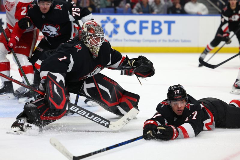 Oct 26, 2024; Buffalo, New York, USA;  Buffalo Sabres goaltender Ukko-Pekka Luukkonen (1) watches for the puck as right wing JJ Peterka (77) tries to block a shot during the third period against the Detroit Red Wings at KeyBank Center. Mandatory Credit: Timothy T. Ludwig-Imagn Images