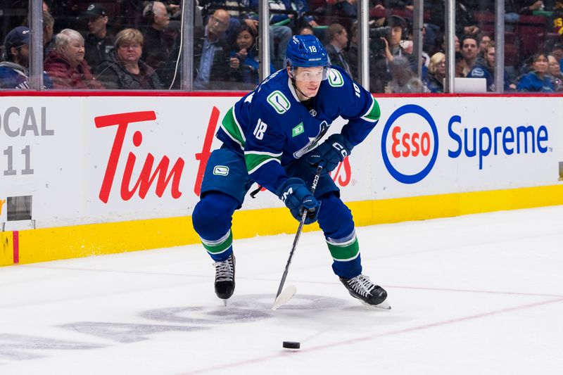 Apr 6, 2023; Vancouver, British Columbia, CAN; Vancouver Canucks forward Jack Studnicka (18) handles the puck against the Chicago Blackhawks in the second period at Rogers Arena. Mandatory Credit: Bob Frid-USA TODAY Sports