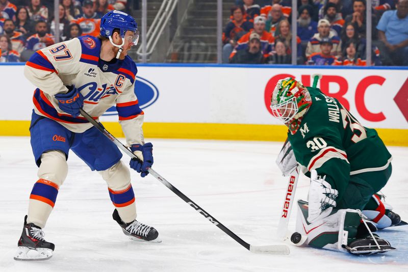 Jan 31, 2026; Edmonton, Alberta, CAN; Minnesota Wild goaltender Jesper Wallstedt (30) makes a save on Edmonton Oilers forward Connor McDavid (97) during the first period at Rogers Place. Mandatory Credit: Perry Nelson-Imagn Images
